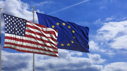 USA and European Union waving flags on blue sky background
