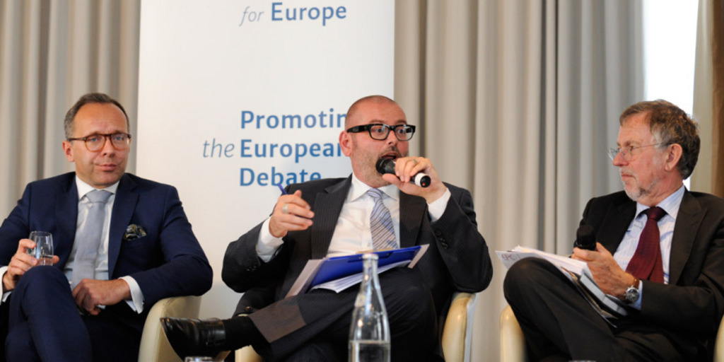Three experts discuss on the podium at an event staged by the New Pact for Europe initiative on July 1, 2014 in Brussels.