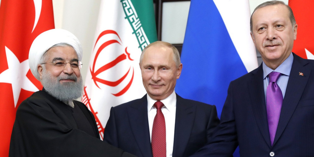 The Presidents of Iran, Russia and Turkey - Hassan Rouhani, Vladmir Putin and Recep Tayyip Erdogan - shake hands at a summit in the Russian city of Sochi.