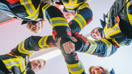 Fire fighter men and women doing some teambuilding stacking