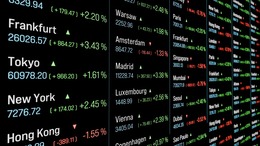 A monitor shows prices at various stock exchanges such as Frankfurt, Tokyo and New York.