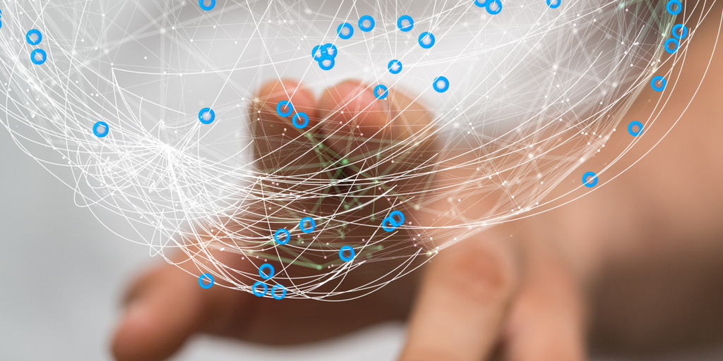 With two fingers, person is touching a graphical display of a globe consisting of connecting lines and dots, symbolizing a network.