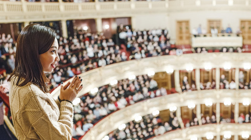 A woman in the theater watches the performance.