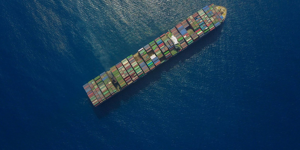 A container ship at sea, photographed from the air