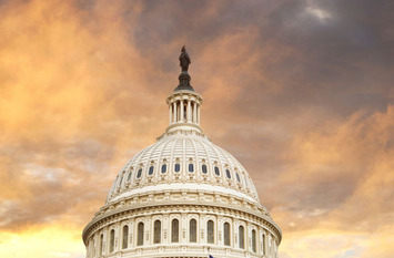 The dome of the United States capitol with an American flag