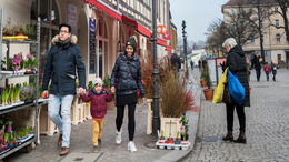 A man, a woman and a child walk through the historical city of Berlin Spandau.