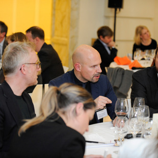 People sitting around a table talking.