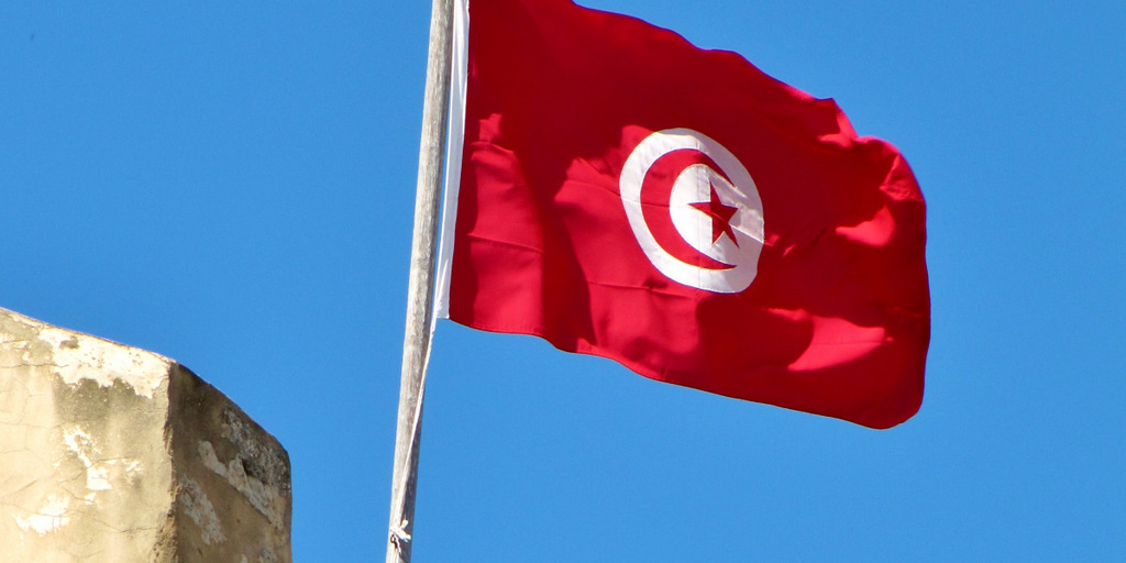 A Tunisian flag is blowing in the wind. 