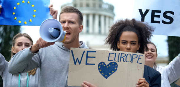 Young protesters with megaphones and Love Europe signs.
