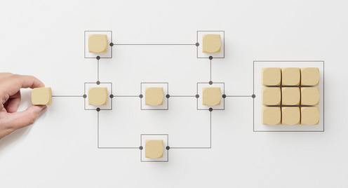 Wooden cubes arranged in a certain way with lines like in an electric circuit model