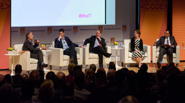 Participants of a discussion panel sit in armchairs on the podium during the Bertelsmann Foundation's annual conference.