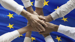 Multicultural hands union concept over European flag