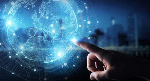 Businessman hand in dark using Europe map globe network hologram