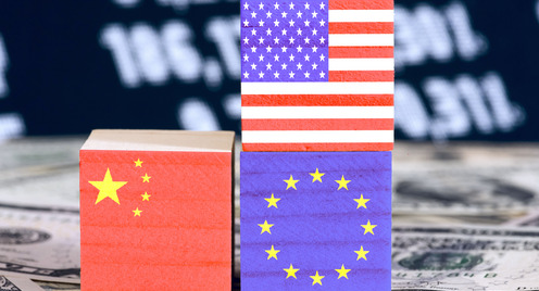 Flags of America, China and the European Union EU on cubes. Dollar notes in the background,