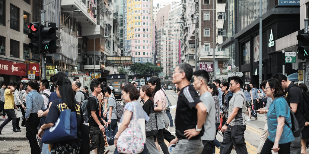 Pedestrians crossing a street in Hong Kong
