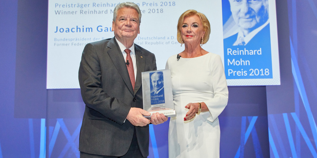 Liz Mohn, Vice Chairman of the Bertelsmann Stiftung Executive Board, presents the Reinhard Mohn Prize to former German President Joachim Gauck on the stage of the Gütersloh Theatre.