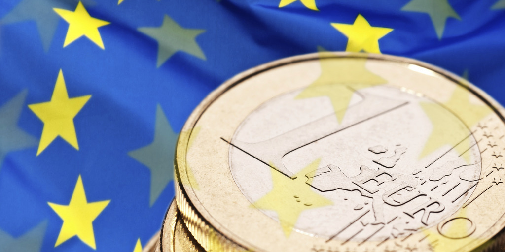 Euro coin and flag of Europe