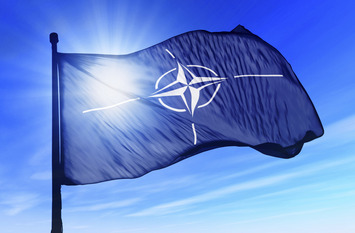 NATO flag waving over the sky