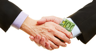 Two Men shake hands and render a 100 Euro Banknote