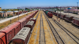 Panorama of railway tracks with trains. The station is visible on the right. Shot in Termez, Uzbekistan