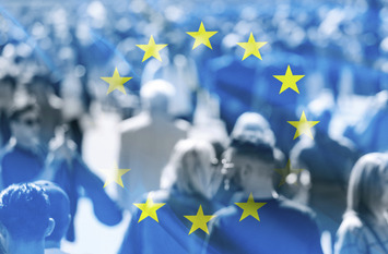 Crowd of people at the city and flag of EU.