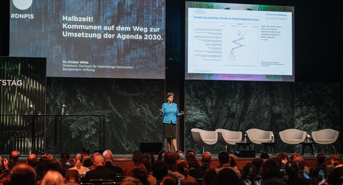 Kirsten Witte, Direktorin des Zentrums für Nachhaltige Kommunen der Bertelsmann Stiftung, ist während ihres Vortrags auf dem Deutschen Nachhaltigkeitstag auf der Bühne zu sehen.