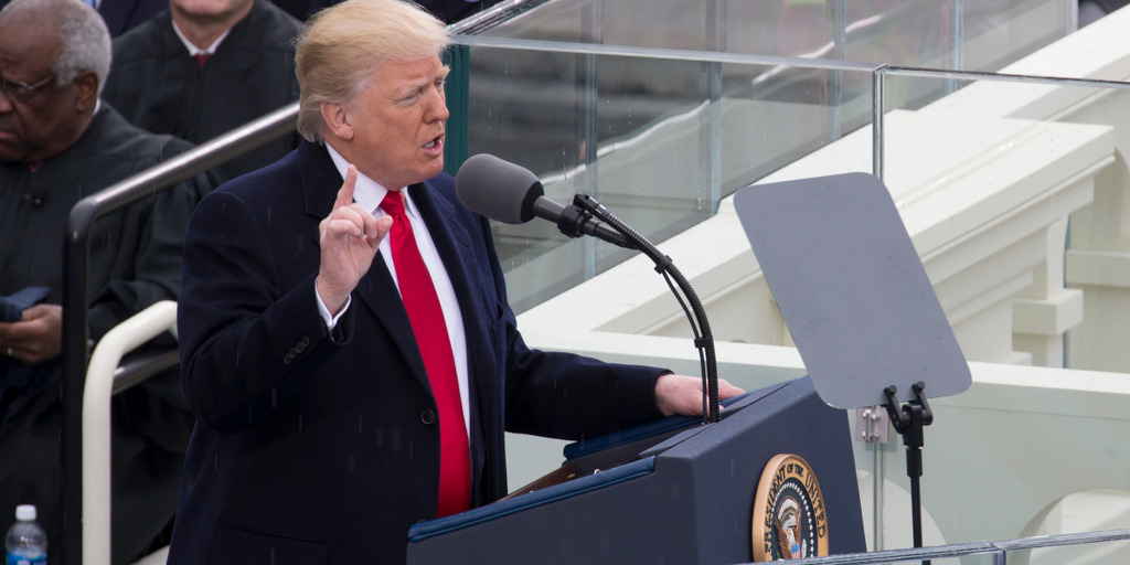 Donald Trump stands behind the lectern during his inaugural speech in front of the Capitol in Washington DC, raising his right index finger while speaking.