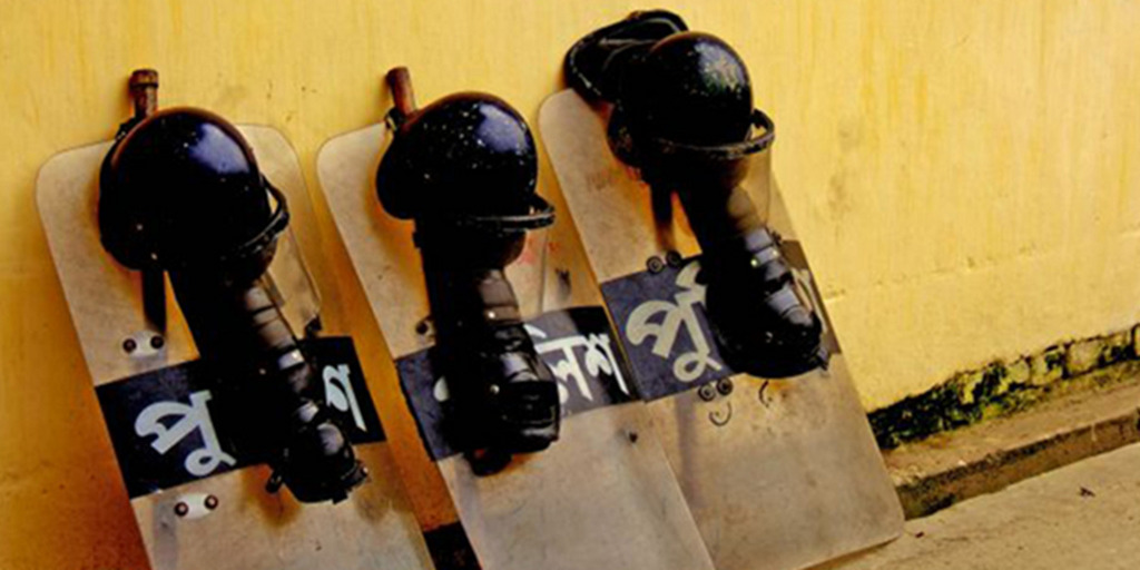 Police riot gear (shields, helmets and leg protectors) can be seen leaning against a wall in the capital of Bangladesh, Dhaka.