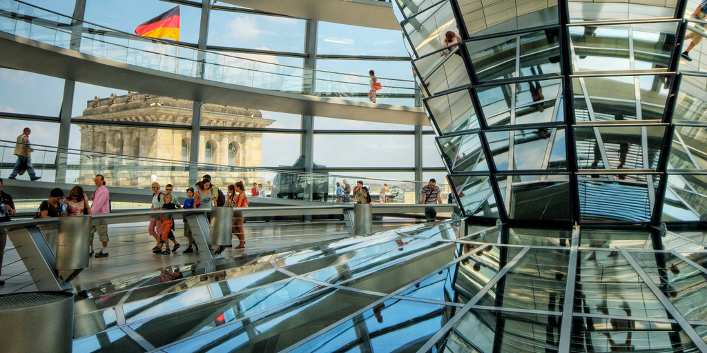 Visitors walk around the glass dome of the Reichstag building in Berlin, seat of the German parliament, the Bundestag.