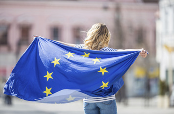 Attractive happy young girl with the flag of the European Union