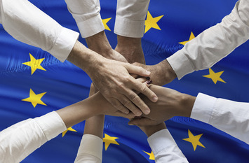 Multicultural hands union concept over European flag