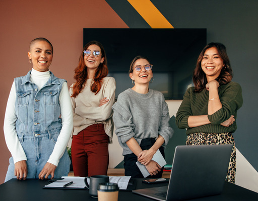 A group of multicultural businesswomen working together in a modern office