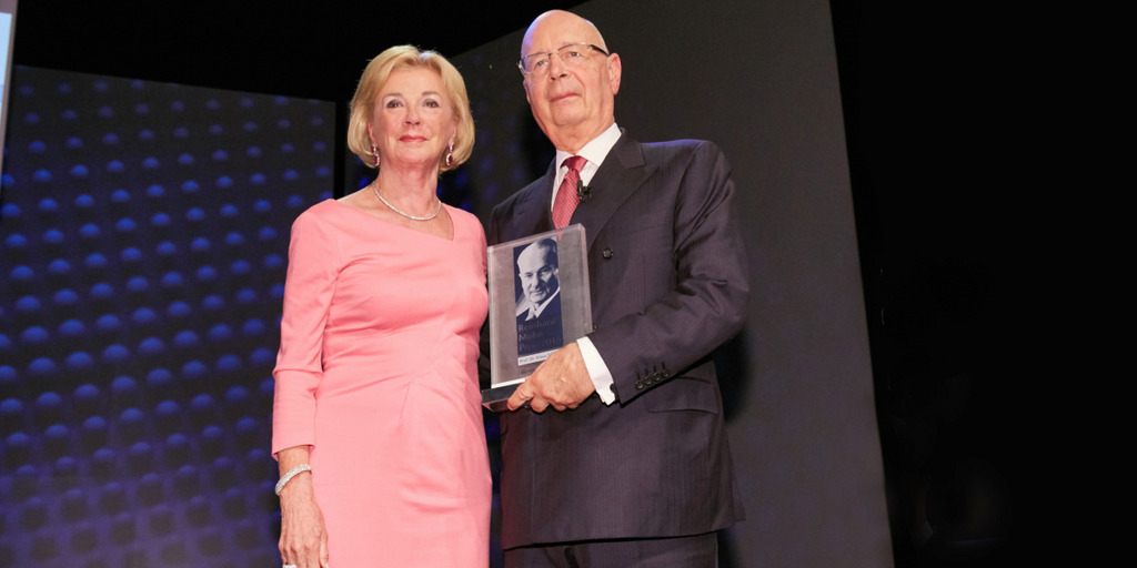 Liz Mohn and Klaus Schwab on a stage in Theatre Gütersloh after the award ceremony of the Reinhard Mohn Prize 2016.
