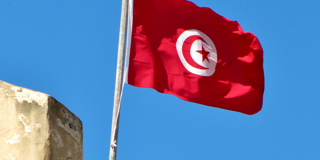 A Tunisian flag is blowing in the wind. 