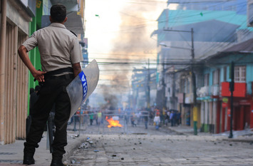 police officer observing violent demonstrators