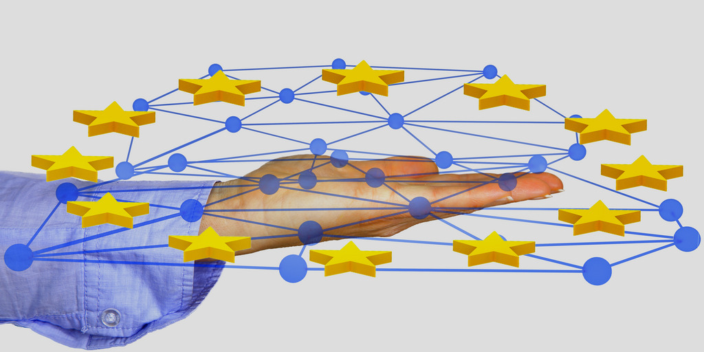 Hand holding network with stars symbolizing the EU flag