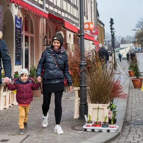 A man, a woman and a child walk through the historical city of Berlin Spandau.
