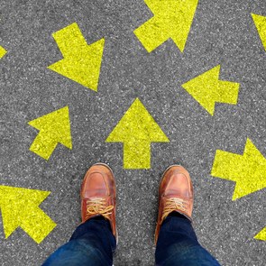 Selfie of shoes and arrows on concrete road